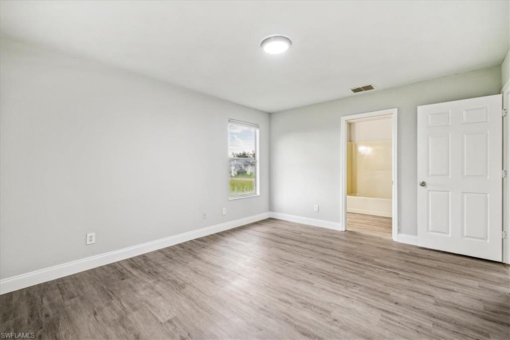 Unfurnished room featuring hardwood / wood-style flooring