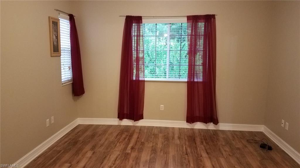 Unfurnished room with hardwood / wood-style flooring