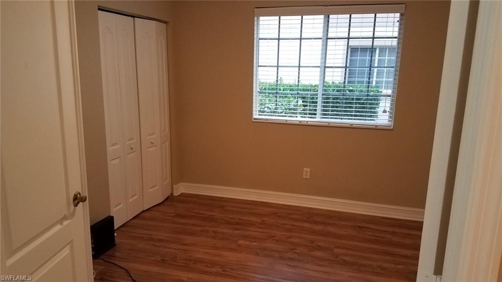 Unfurnished bedroom with a closet and dark wood-type flooring
