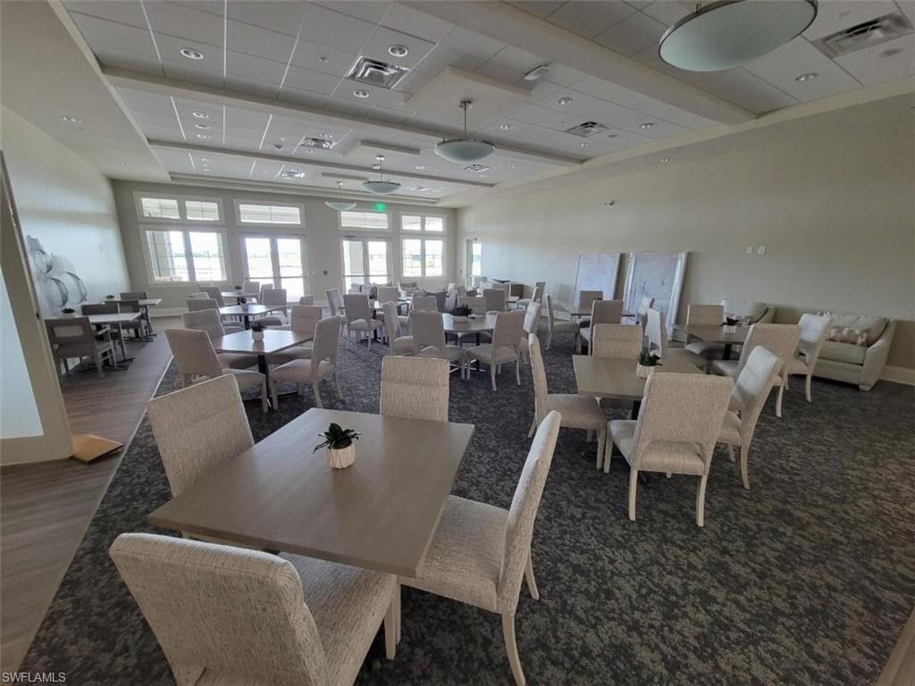 Carpeted dining room featuring a drop ceiling
