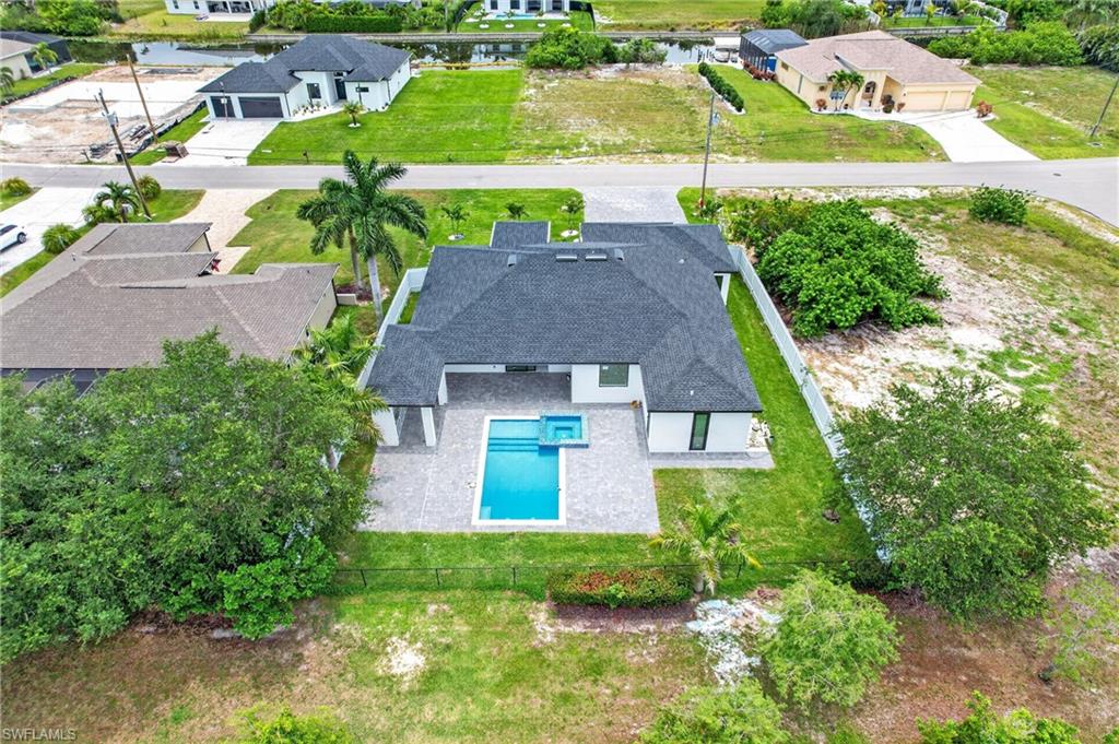 Modern single-story residence featuring a dark gray shingle roof and white exterior