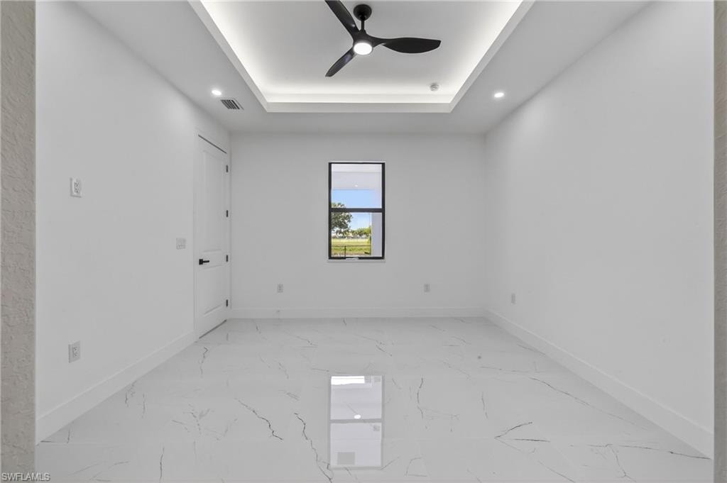 Bright interior space featuring white walls and large format tile flooring