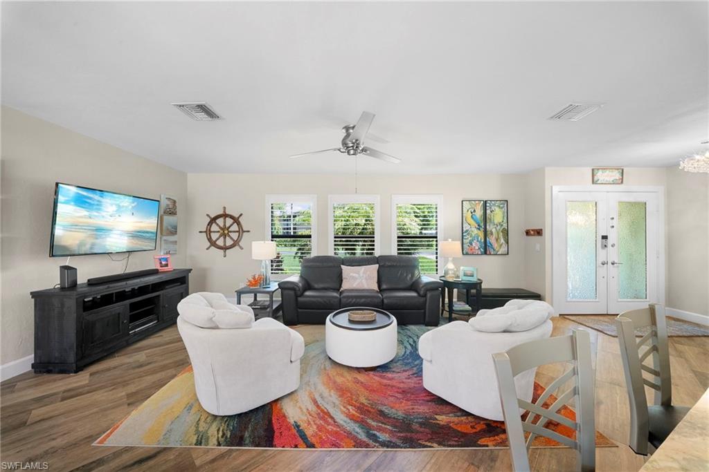 Open-concept living space featuring wood-finish flooring, recessed lighting, and a ceiling fan