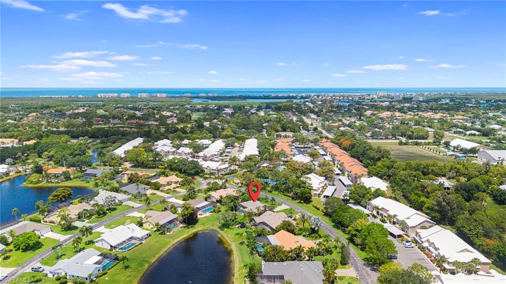 Aerial perspective showcasing property within a lush, developed neighborhood
