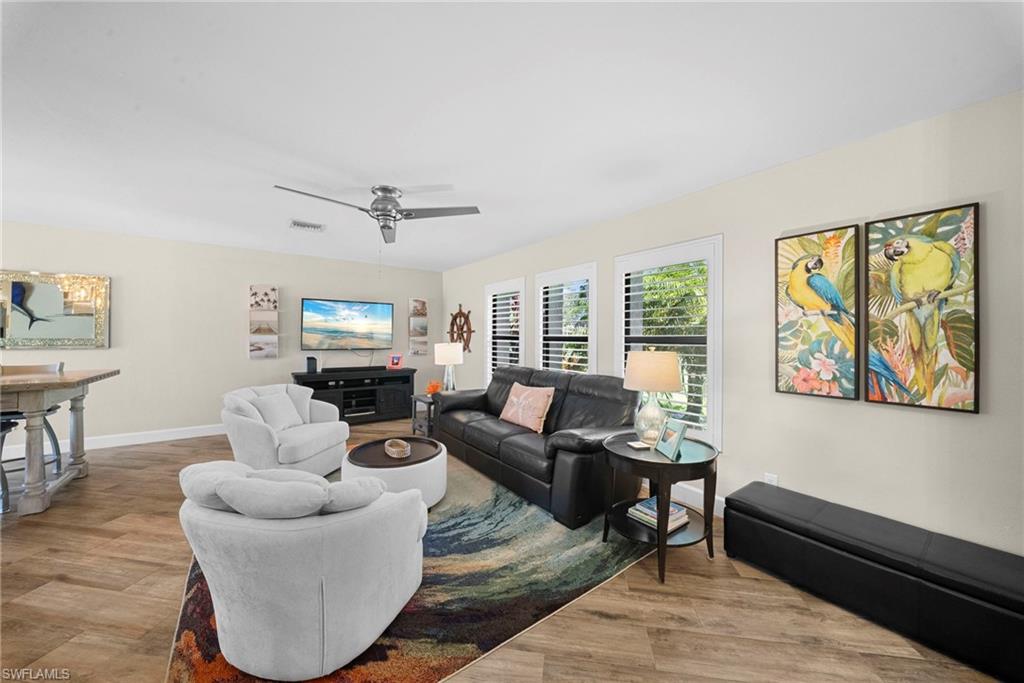 Living area featuring wood-finish flooring and light-toned walls