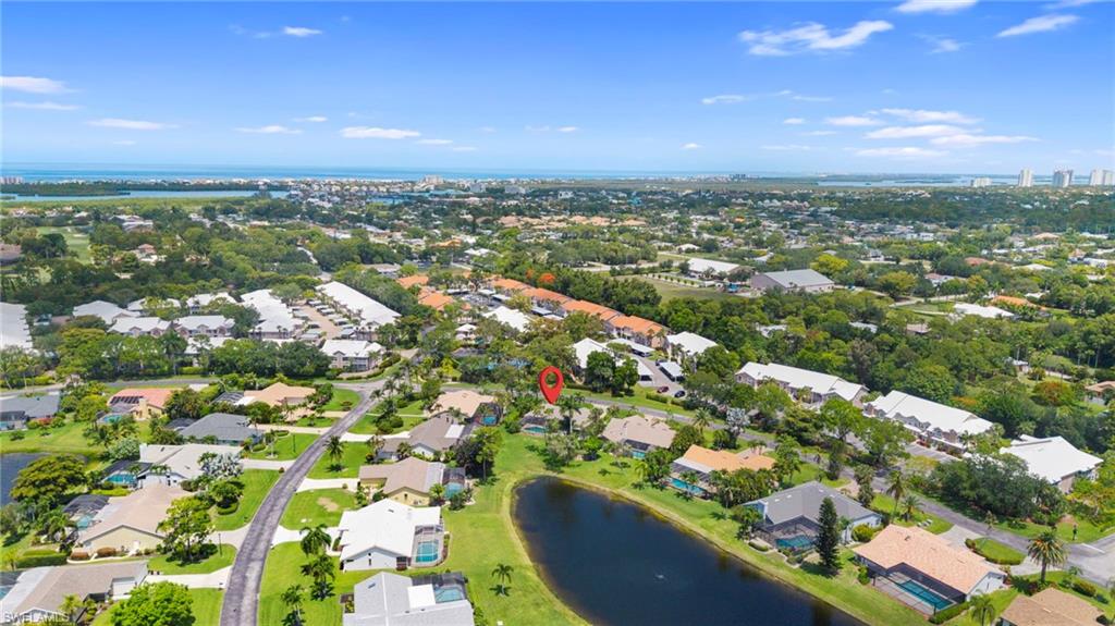 Aerial perspective highlighting a residential neighborhood with a prominent body of water