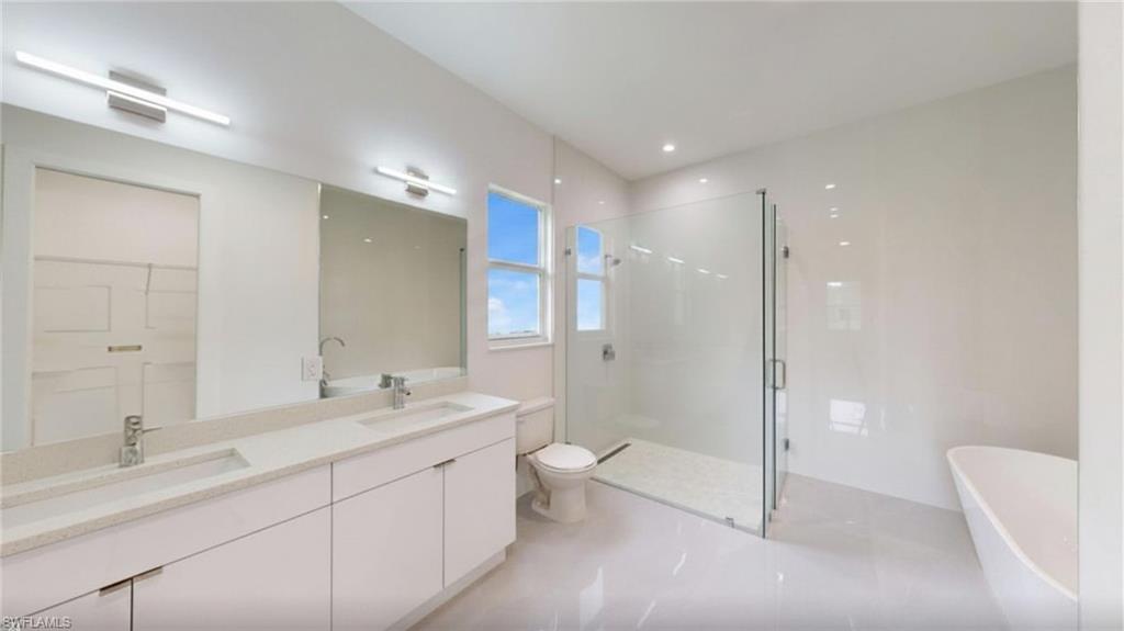 Double vanity, shower, and freestanding tub