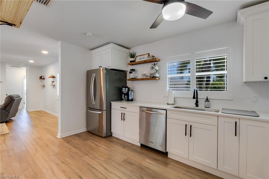 Open concept kitchen connecting kitchen and living spaces