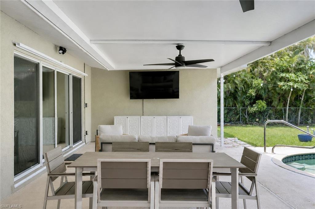Outdoor dining and lounge space overlooking the pool