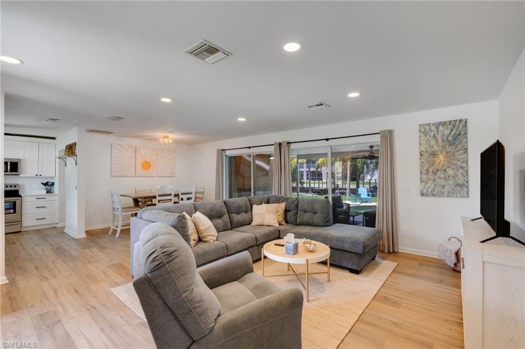 Open concept living with pool views