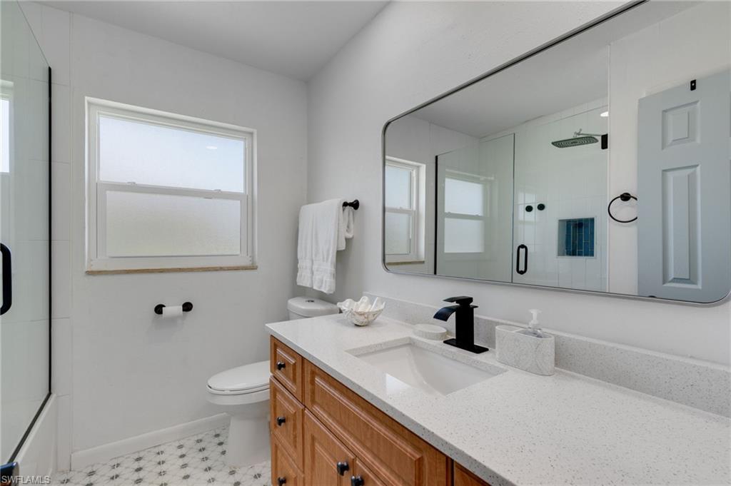 Updated guest bath with quartz vanity and walk-in shower