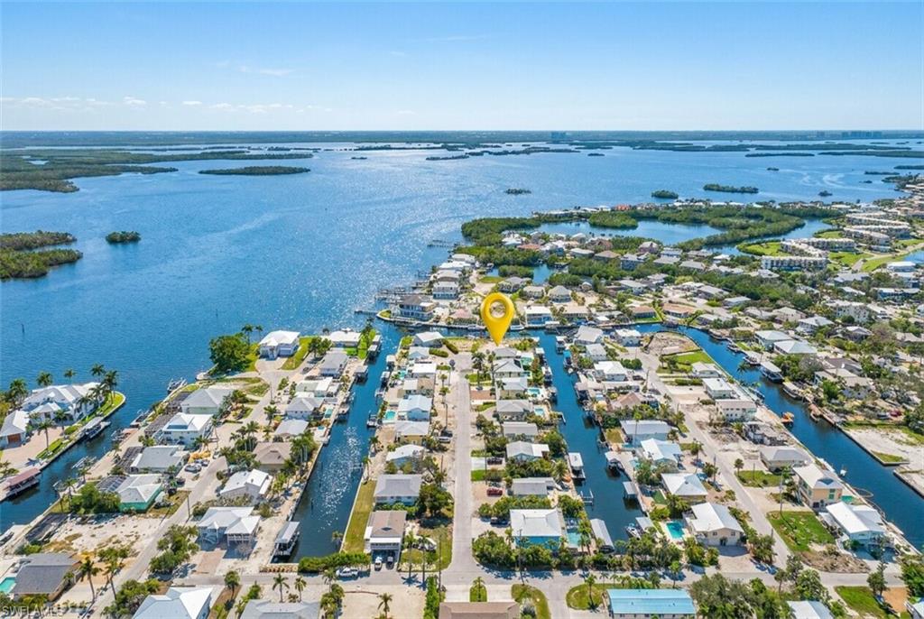 Aerial perspective showcasing a canal-front property within a waterfront community - Virtually Edited Image
