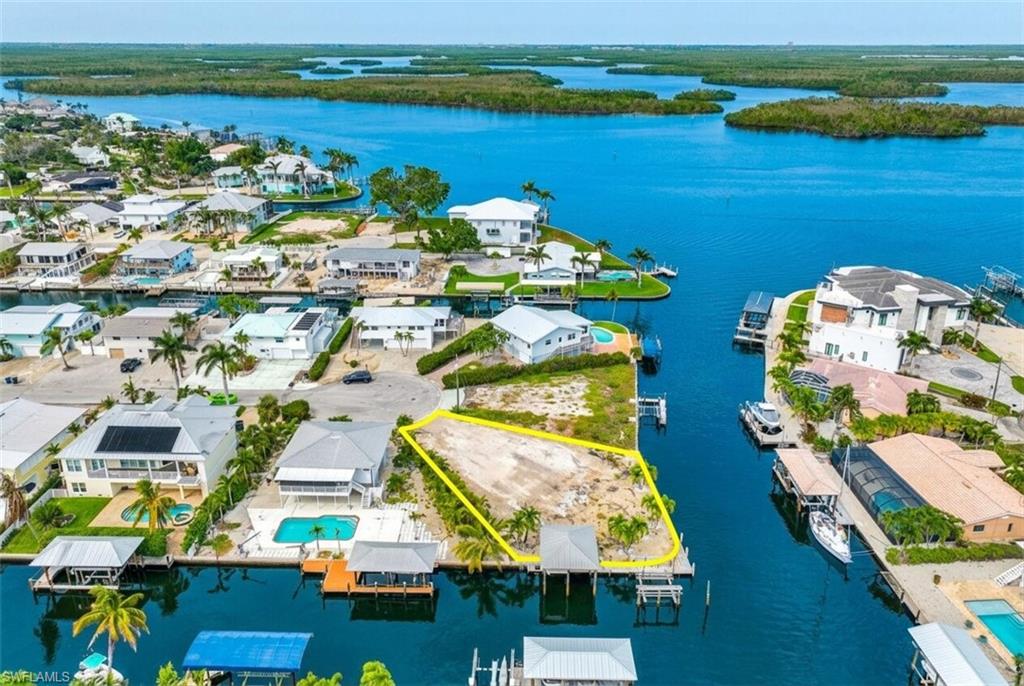 Waterfront lot with direct Gulf access, featuring a private boat dock and canal frontage - Virtually Edited Image