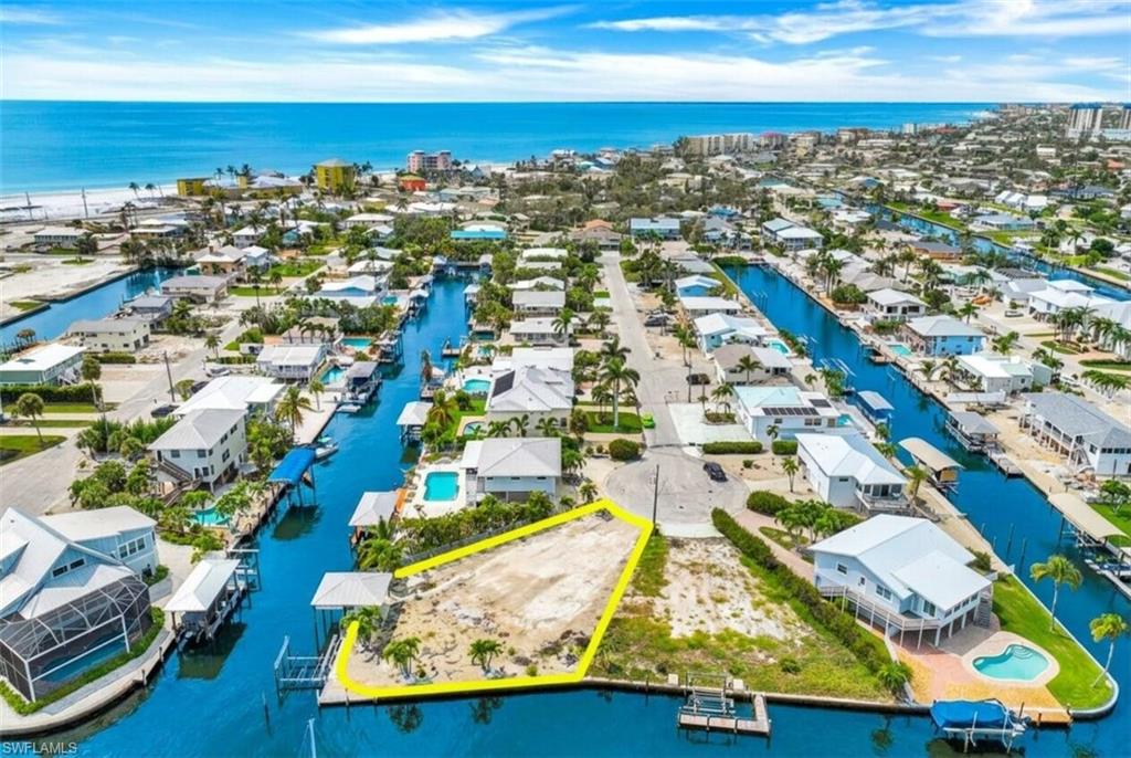 Vacant lot featuring direct canal frontage and a private boat dock - Virtually Edited Image