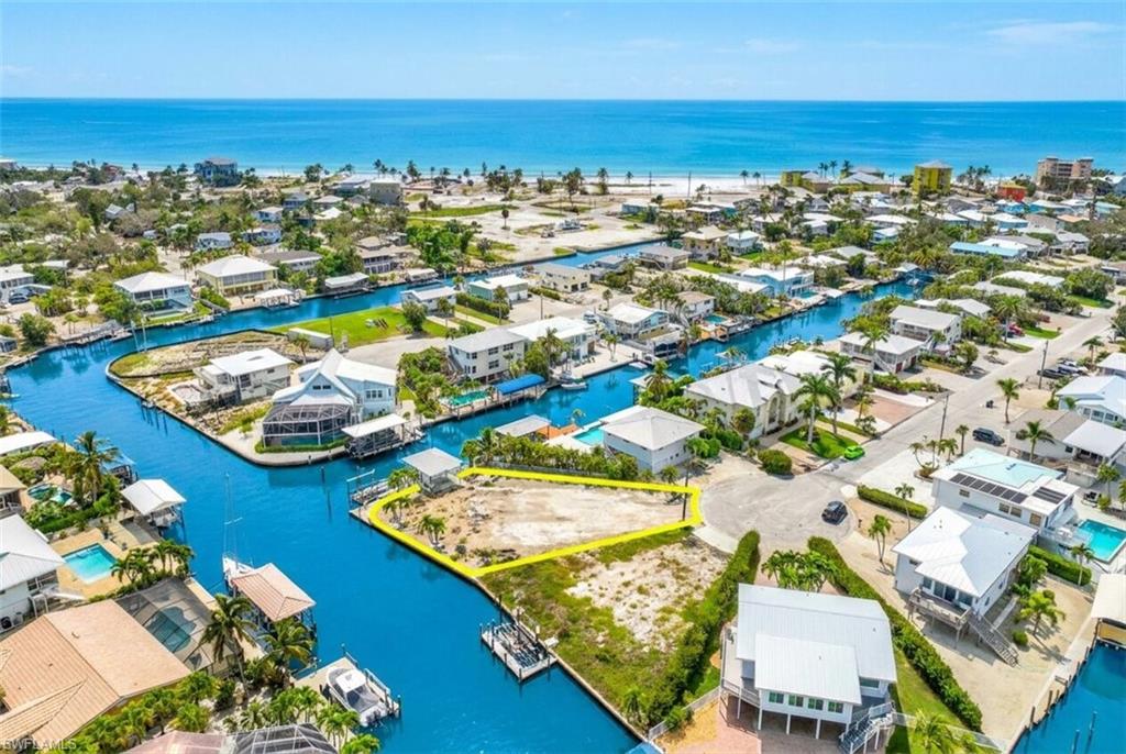 Waterfront parcel with direct canal access, surrounded by residential properties and established infrastructure - Virtually Edited Image