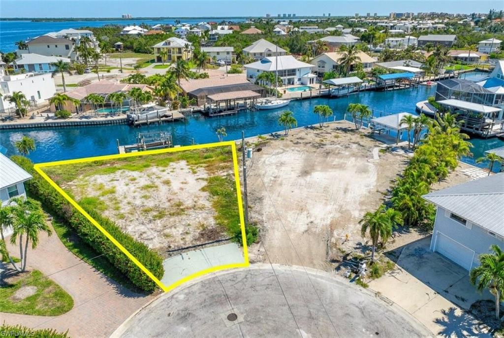 Waterfront lot with direct canal access, featuring a seawall and cul-de-sac frontage - Virtually Edited Image