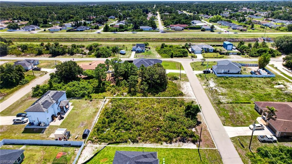 Vacant land parcel featuring mature vegetation and surrounding residential properties