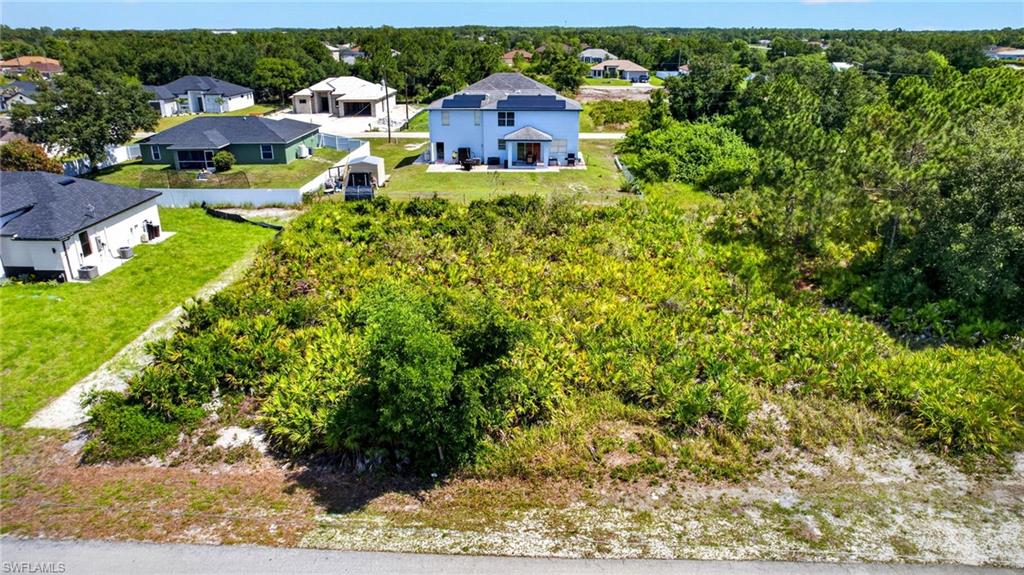 Residential lot featuring natural vegetation and partial clearing