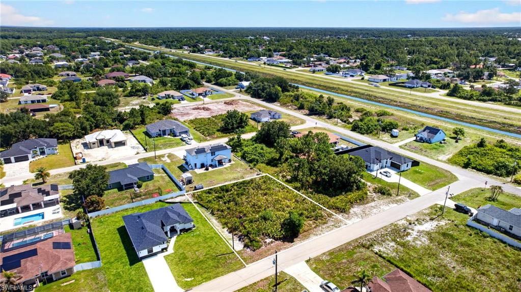 Vacant lot with existing road frontage, surrounded by a developing residential area