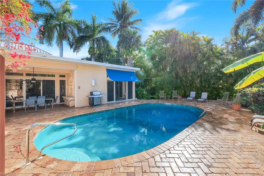 Outdoor pool featuring a patio and grilling area
