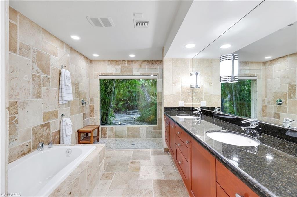 Bring the outdoors into the large privateshower in the private primary bath.