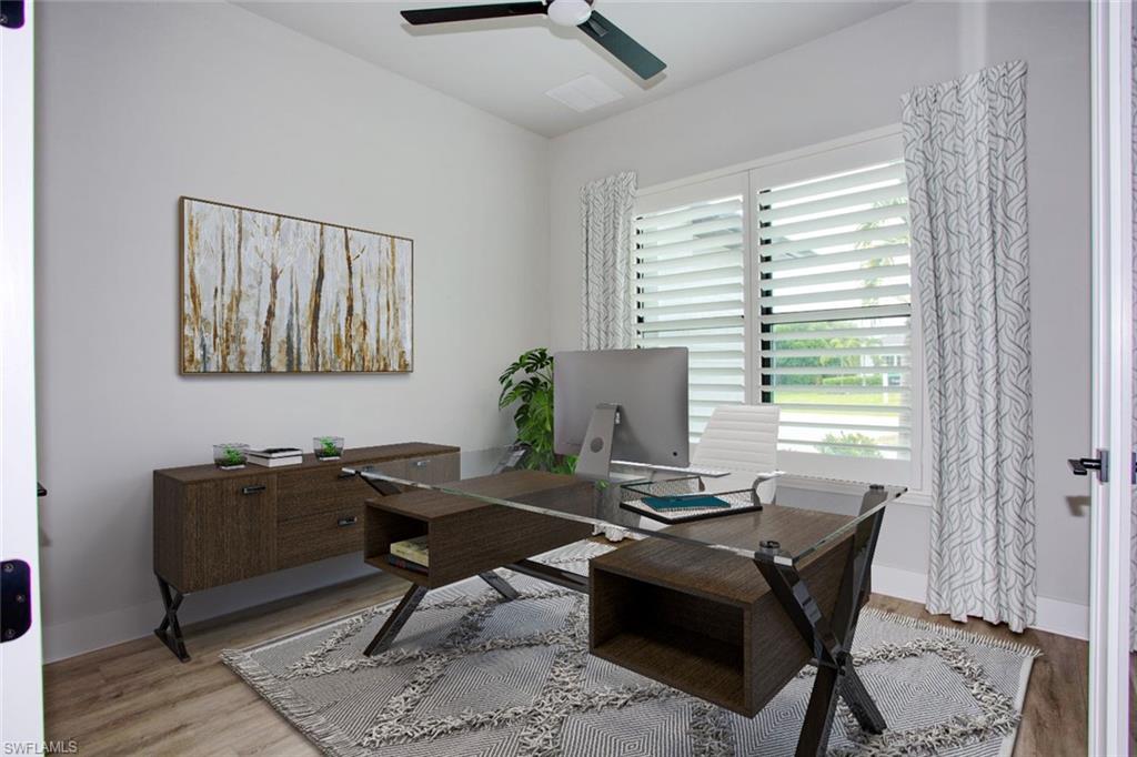 Dedicated room featuring wood-finish flooring, white plantation shutters, a contemporary ceiling fan, and ample natural light