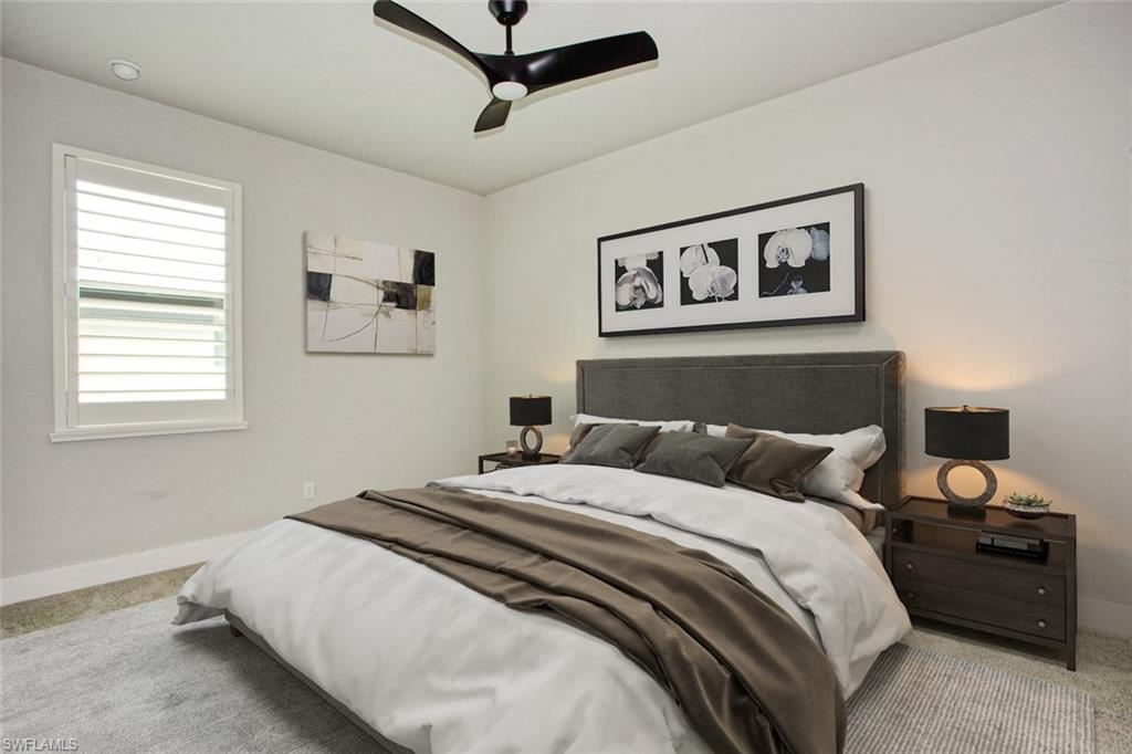 Bedroom featuring a ceiling fan, window with plantation shutters, recessed lighting, and a neutral color palette