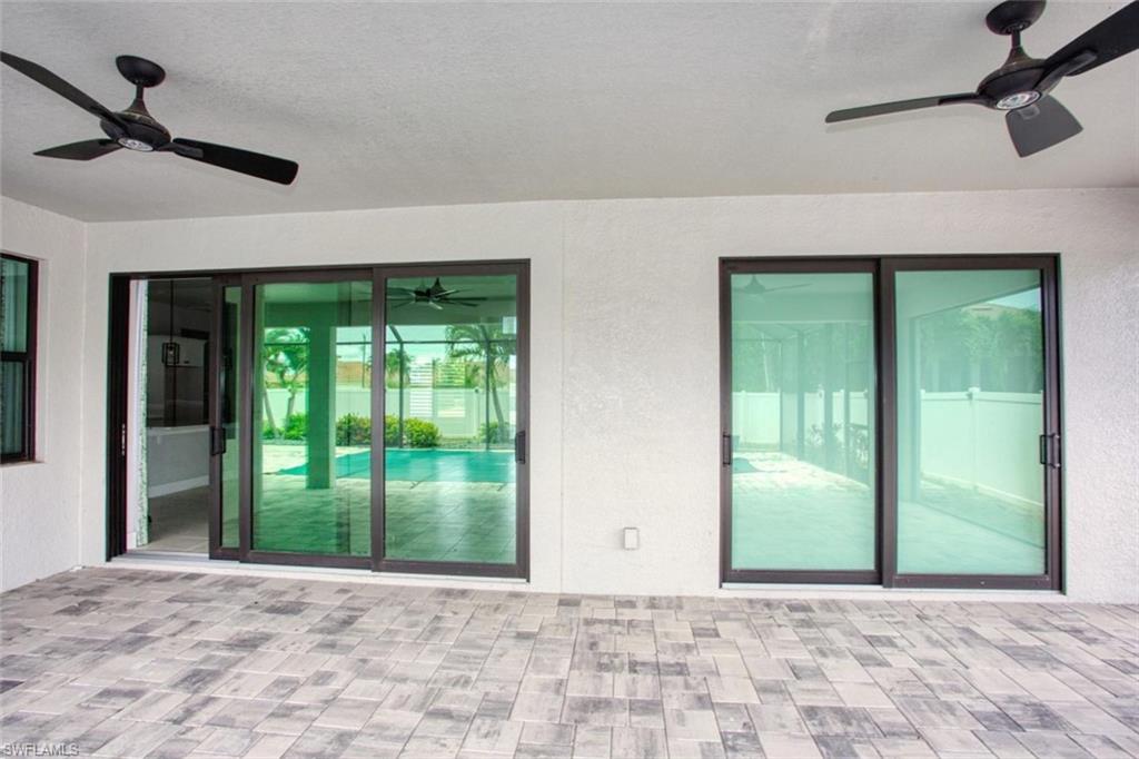 Pavered area by the sparkling pool.