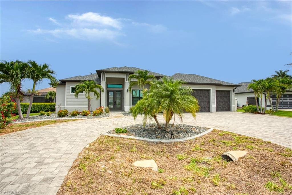 Contemporary exterior with a double-door entry, decorative columns, and a paved driveway