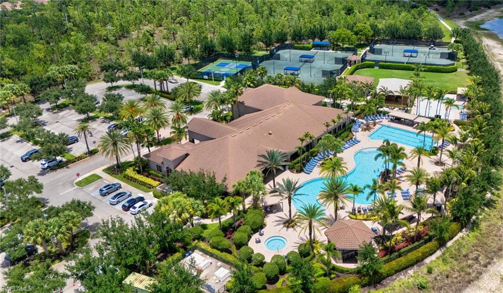 Expansive community amenities featuring a large clubhouse, two swimming pools, a spa, and multiple tennis courts