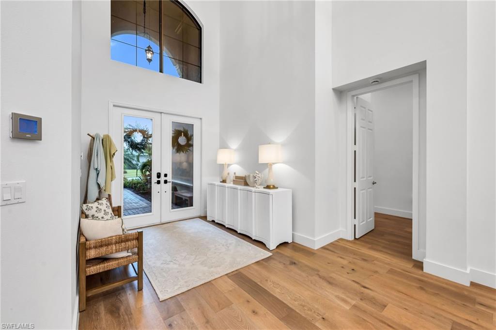 Double glass entry doors with an arched transom window