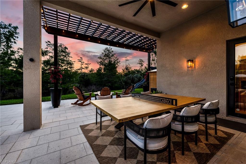Covered patio featuring a wooded pergola, Market lighting, and a ceiling fan