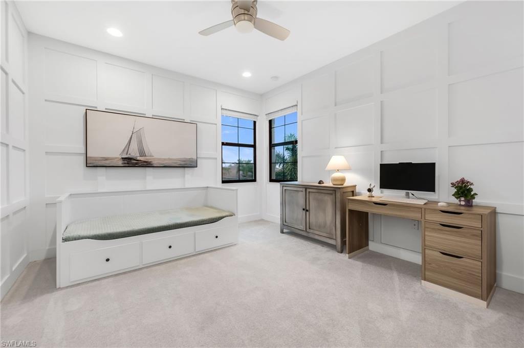 Room featuring board and batten wall detailing, recessed lighting, and a ceiling fan