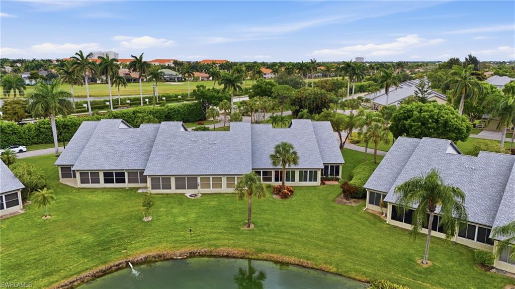 Expansive property featuring multiple single-story structures with gray shingle roofs, surrounded by manicured lawns