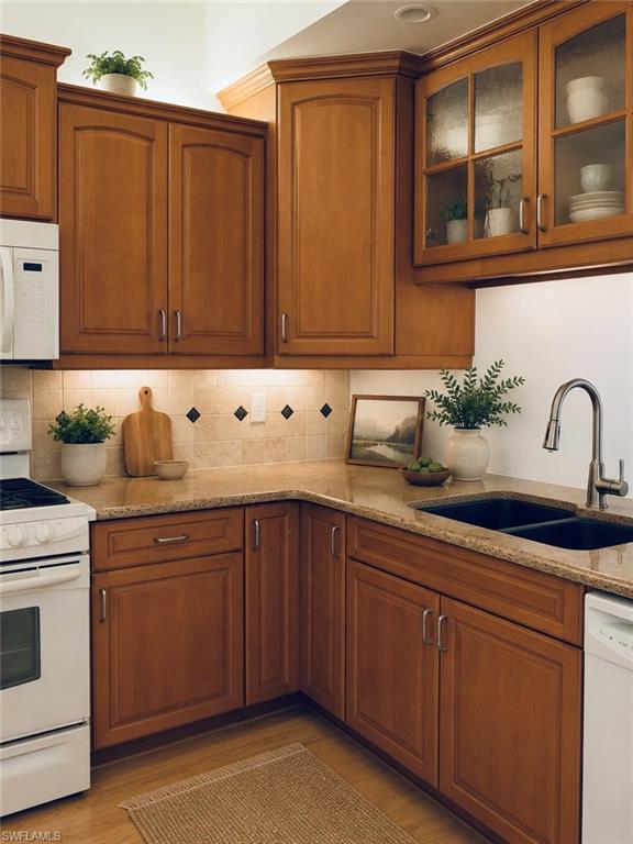 *Virtually Staged* U-shaped kitchen with wood cabinetry and granite countertops
