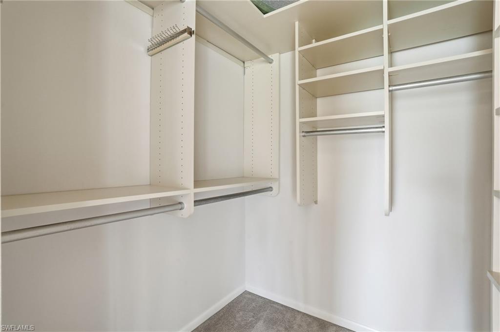 Customizable closet system featuring adjustable shelving, multiple hanging rods, and an integrated tie rack
