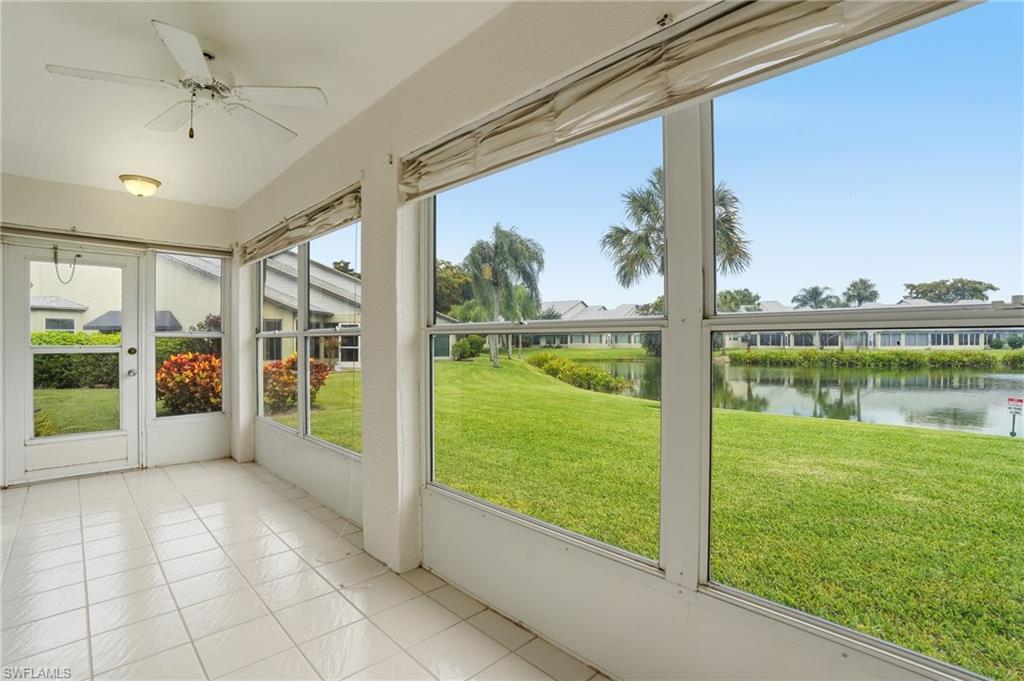 Enclosed patio featuring white tile flooring and a ceiling fan with integrated lighting