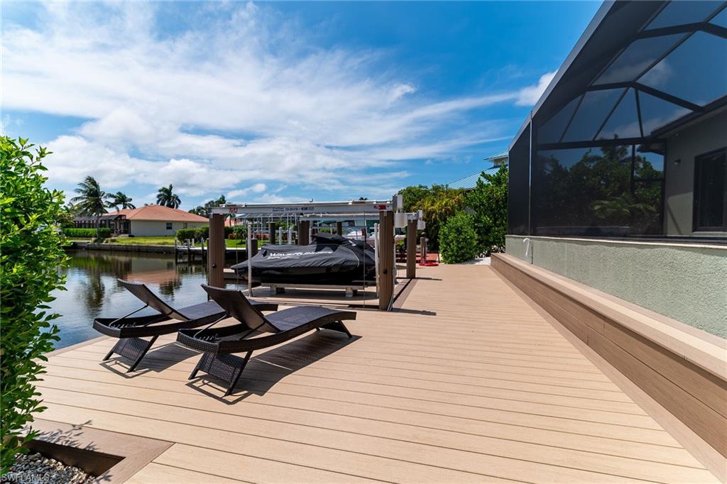 Waterfront composite decking featuring a boat lift and screened enclosure