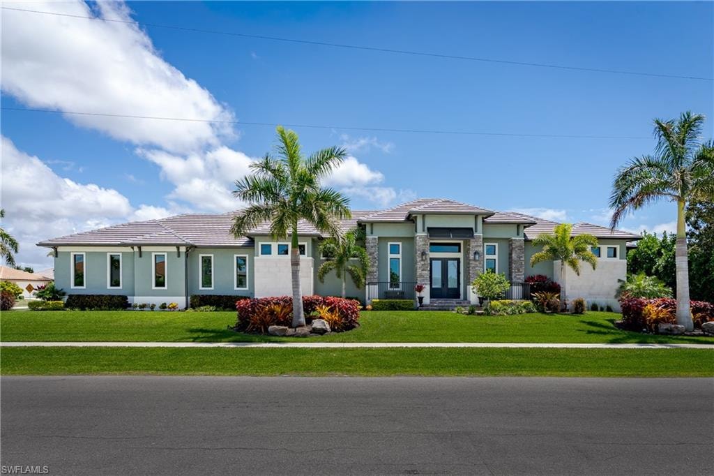 Contemporary exterior with a light stucco finish, stone accents, and a covered entry