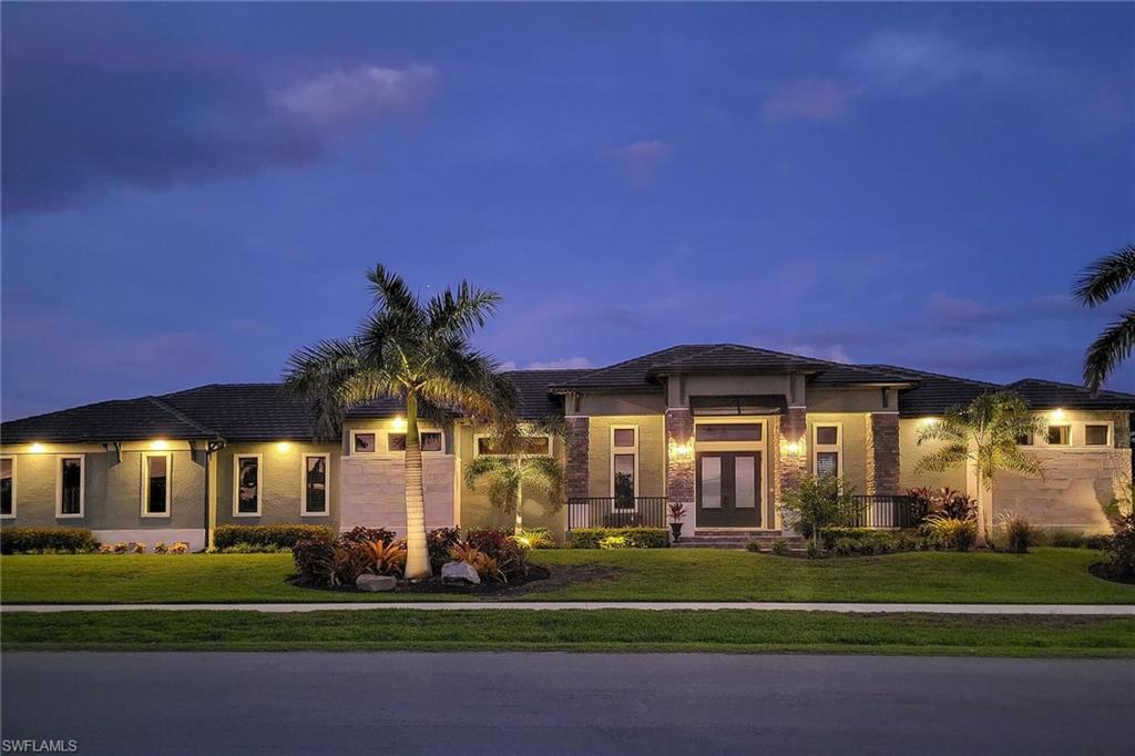 Modern single-story residence with a dark roof and light-colored exterior