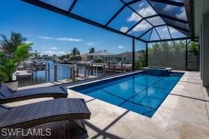 Screened lanai featuring a swimming pool, integrated spa, and direct waterfront access with a dock
