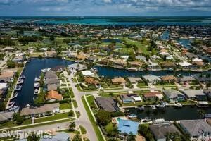 Aerial perspective showcasing a canal-front community with numerous properties featuring private boat docks