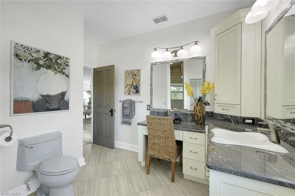 Large guest bathroom features a vanity and huge walk-in shower.