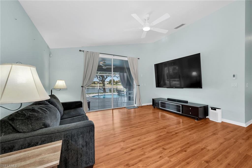 Spacious interior featuring wood-finish flooring and vaulted ceilings