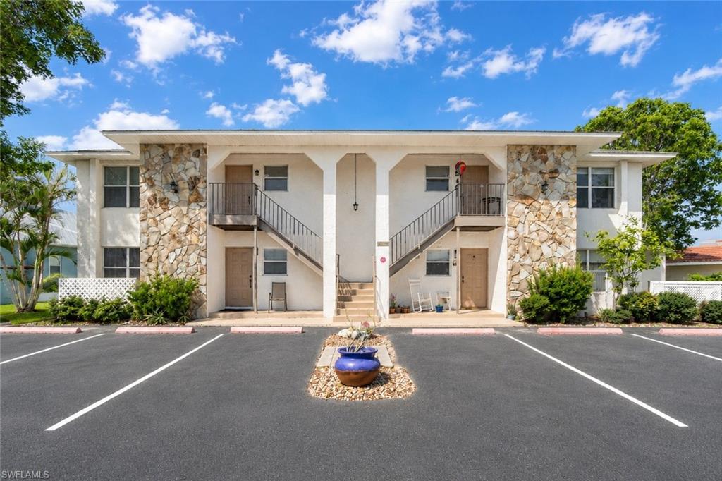 Two-story building featuring natural stone facade accents and white exterior finishes