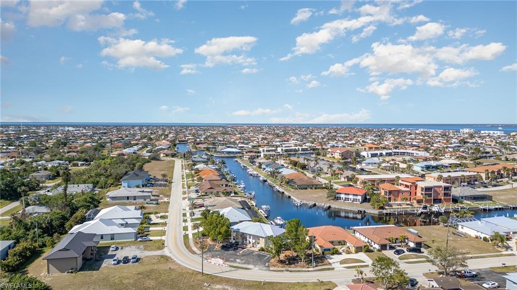 Aerial perspective of a developed residential area with canal access