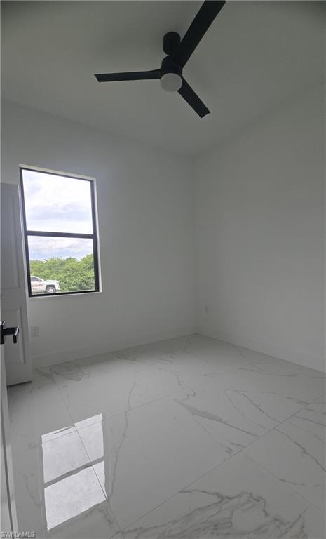 Room featuring white walls, large format tile flooring, a dark-framed window, and a ceiling fan with integrated lighting