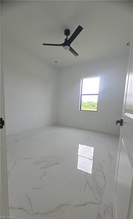 Spacious room featuring large format porcelain tile flooring, a modern black ceiling fan, recessed lighting, white walls, and a window providing natural light