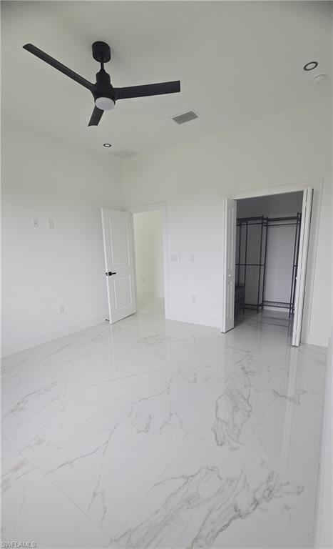 Spacious room featuring large format tile flooring, a contemporary black ceiling fan, recessed lighting, and crisp white walls