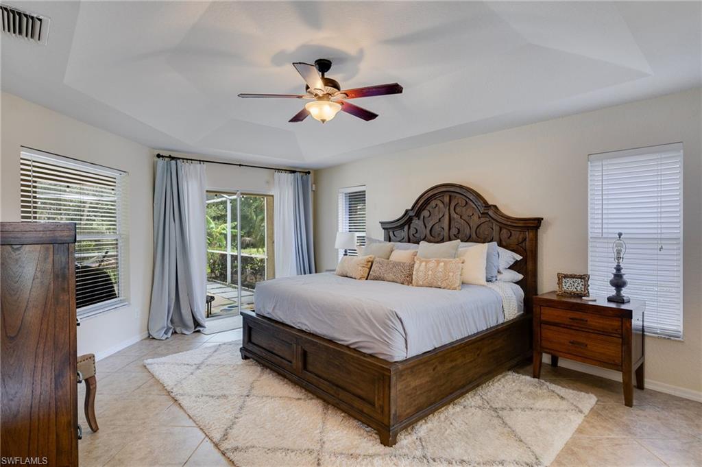 Spacious tiled owners suite with view of the backyard and entrance to the Lanai. More than enough room for a king sized bed set.